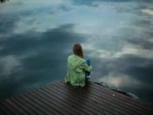 Woman Sitting on Wooden Planks