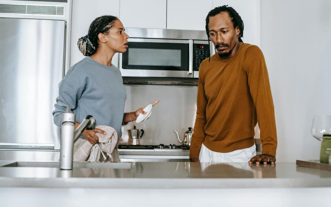 Black couple talking on kitchen