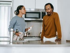 Black couple talking on kitchen